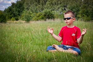 young boy in meditation pose