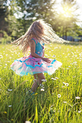young girl dancing in the sunshine