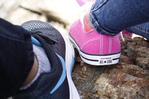 girl's shoe next to guy's shoe