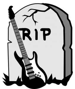 electric guitar leaning against a tombstone