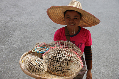 woman holding a cage of birds