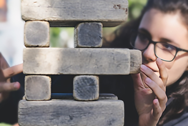young woman playing Jenga