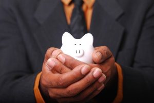 business man holding piggy bank