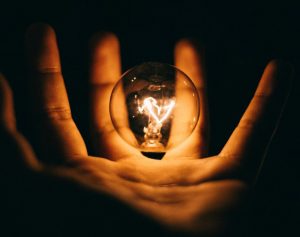 light bulb hovering over an open hand