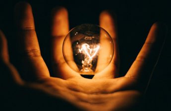 light bulb hovering over an open hand