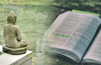 meditating Buddha statue and a Bible