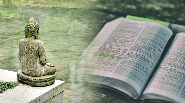 meditating Buddha statue and a Bible