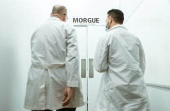 doctors in front of entrance to morgue