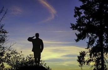 silhouette of man saluting